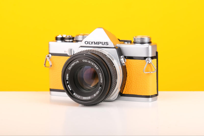 Olympus OM-1 35mm SLR Film Camera with Olympus OM-System Zuiko Auto-S 50mm f1.8 Lens in Yellow