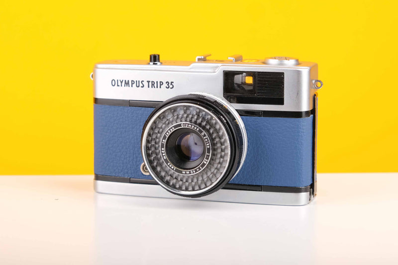 Vintage Olympus camera on a yellow background