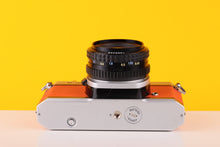 Load image into Gallery viewer, Pentax K1000 35mm Film Camera with SMC-M 50mm f/1.7 Prime Lens in Orange
