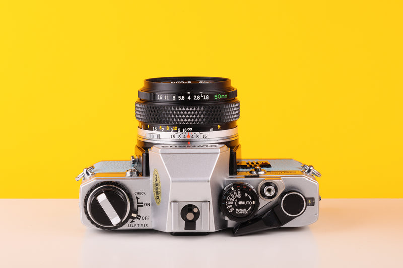 Olympus OM10 35mm Film Camera with Olympus Auto-S 50mm f1.8 MC Lens in Blue