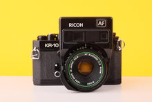 Load image into Gallery viewer, Ricoh camera with 'KR-10' and 'AF' branding on a yellow background
