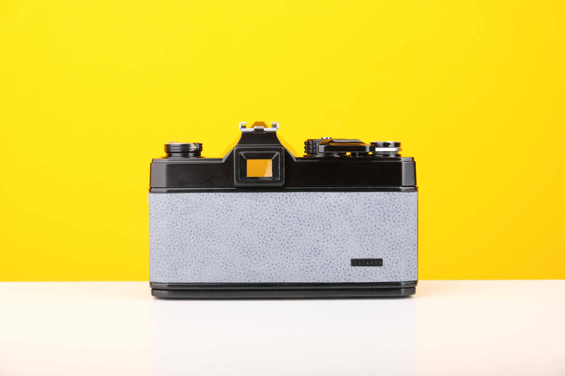 Topcon RE 200 35mm SLR Film Camera with RE Topcor 55mm f1.7 Lens in Grey