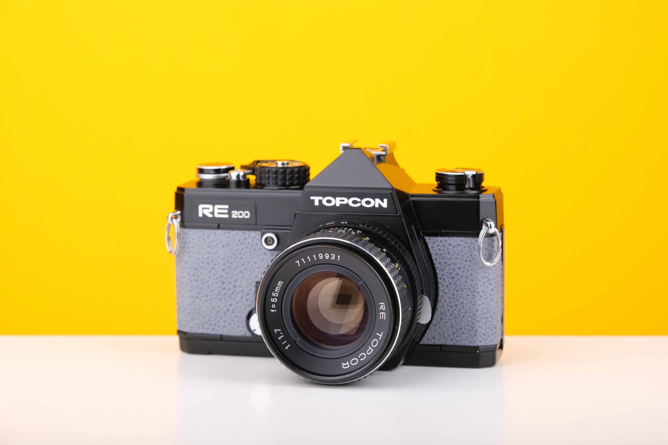 Topcon RE 200 35mm SLR Film Camera with RE Topcor 55mm f1.7 Lens in Grey