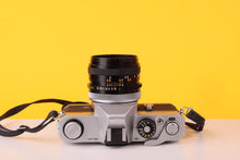 Load image into Gallery viewer, Canon TX 35mm SLR Film Camera + Canon FD 50mm f/1.8 S.C. Lens
