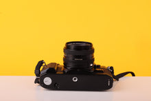 Load image into Gallery viewer, Canon AE-1 Program Black 35mm Film Camera with Canon FD 50mm f/1.8 Lens
