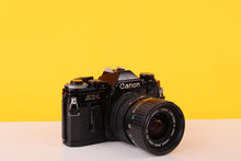 Load image into Gallery viewer, Canon AE-1 Black 35mm SLR Film Camera with Canon FD 35-70mm f/3.5-4.5 Zoom Lens
