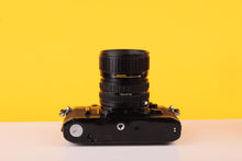 Load image into Gallery viewer, Canon AE-1 Black 35mm SLR Film Camera with Canon FD 35-70mm f/3.5-4.5 Zoom Lens
