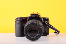 Load image into Gallery viewer, Canon EOS 10 35mm SLR Film Camera with Sigma UC Zoom 70–210mm f/4–5.6 Lens
