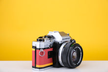 Load image into Gallery viewer, Olympus OM10 Slr Vintage 35mm Film Camera with Zuiko 50mm f1.8 Prime Lens  and Manual Adapter With New Leather Red and Yellow Skin
