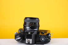 Load image into Gallery viewer, Nikon EM 35mm SLR Film Camera with 28mm lens and Grip
