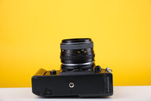 Load image into Gallery viewer, Nikon EM 35mm SLR Film Camera with 28mm lens and Grip
