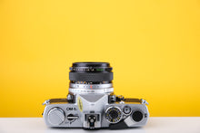 Load image into Gallery viewer, Olympus OM-1n 35mm SLR Film Camera with Zuiko 50mm f1.8 Lens
