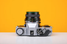 Load image into Gallery viewer, Olympus OM20 35mm Film Camera with Hanimex 28mm f/2.8 Lens
