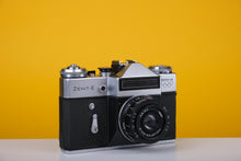Load image into Gallery viewer, Zenit E Vintage Russian 35mm Film SLR Camera with Industar 50mm f/2Lens and Lens Hood
