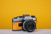 Load image into Gallery viewer, Olympus OM10 Vintage Film Camera with 50mm f/1.8 Lens With New Leather Yellow Skin
