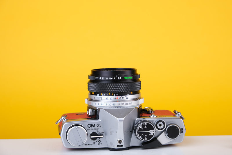 Olympus OM2n MD 35mm Film Camera with Zuiko 28mm f2.8 Lens Filter Reconditioned with Red Leather Skin