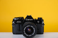 Load image into Gallery viewer, Canon AE-1 Black 35mm SLR Film Camera with Canon Zoom FD 35-70mm f3.5-4.5 Lens
