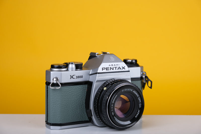 Pentax K1000 35mm Film Camera with SMC Pentax M 50mm f/1.7 Prime Lens and New Grey Leather Skin