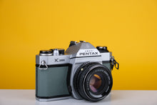 Load image into Gallery viewer, Pentax K1000 35mm Film Camera with SMC Pentax M 50mm f/1.7 Prime Lens and New Grey Leather Skin
