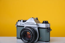 Load image into Gallery viewer, Pentax K1000 35mm Film Camera with SMC Pentax M 50mm f/1.7 Prime Lens and New Grey Leather Skin
