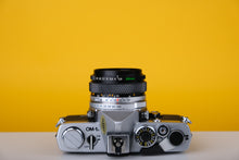 Load image into Gallery viewer, Olympus OM-1n 35mm SLR Film Camera with Zuiko 28mm f2.8 Lens
