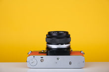 Load image into Gallery viewer, Olympus OM10 Vintage Film Camera with 50mm f/1.8 Lens With New Orange Leather Skin
