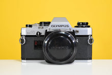 Load image into Gallery viewer, Olympus Om10 Slr Vintage 35mm Film Camera with Zuiko 50mm f1.8 Prime Lens, Lens Filter, Strap and Olympus Manual Adapter
