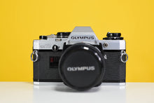 Load image into Gallery viewer, Olympus Om10 Slr Vintage 35mm Film Camera with Zuiko 50mm f1.8 Prime Lens, Lens Filter, Strap and Olympus Manual Adapter
