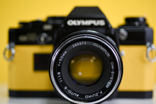 Load image into Gallery viewer, Olympus OM10 SLR Black Vintage 35mm Film Camera with Zuiko 50mm f/1.8 Prime Lens New Leather Yellow Skin
