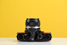 Load image into Gallery viewer, Olympus OM-1 Black Vintage 35mm Film Camera with Zuiko 50mm f/1.4 Lens New Orange Leather Skin
