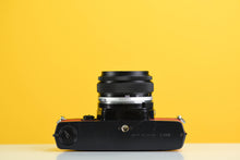 Load image into Gallery viewer, Olympus OM-1 Black 35mm Film Camera with Zuiko 50mm f/1.8 Prime Lens Red Leather Skin
