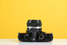 Load image into Gallery viewer, Olympus OM-1 Black 35mm Film Camera with Zuiko 50mm f/1.8 Prime Lens Red Leather Skin
