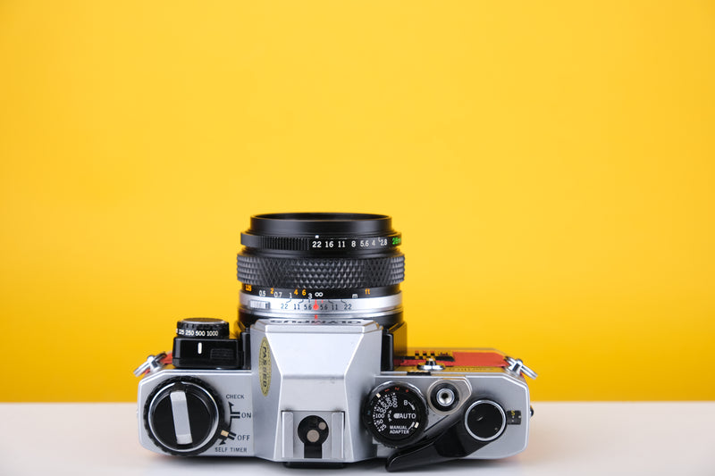 Olympus OM10 35mm SLR Film Camera with Zuiko 28mm f2.8 Prime Lens  and Manual Adapter With New Leather Red and Yellow Skin