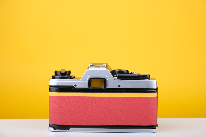 Olympus OM10 35mm SLR Film Camera with Zuiko 28mm f2.8 Prime Lens  and Manual Adapter With New Leather Red and Yellow Skin