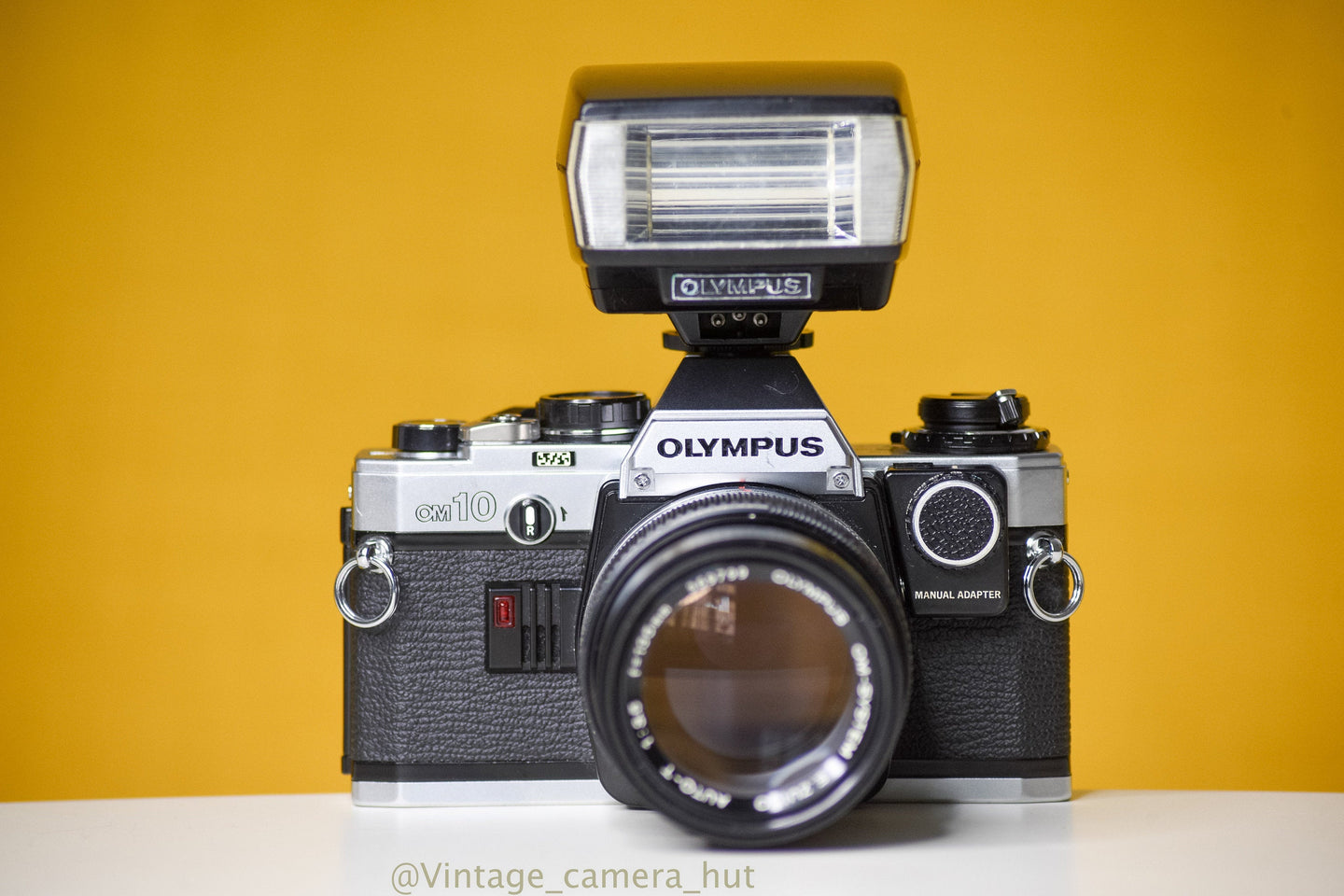 Olympus OM10 SLR Vintage 35mm Film Camera with Zuiko Auto-T 135mm f3.5 Prime Lens with Manual Adapter And Olympus Flash