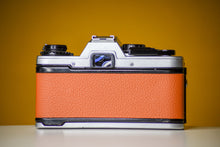 Load image into Gallery viewer, Olympus OM10 Slr Vintage 35mm Film Camera with Zuiko 50mm f/1.8 Prime Lens and Manual Adapter Reconditioned with Orange Skin
